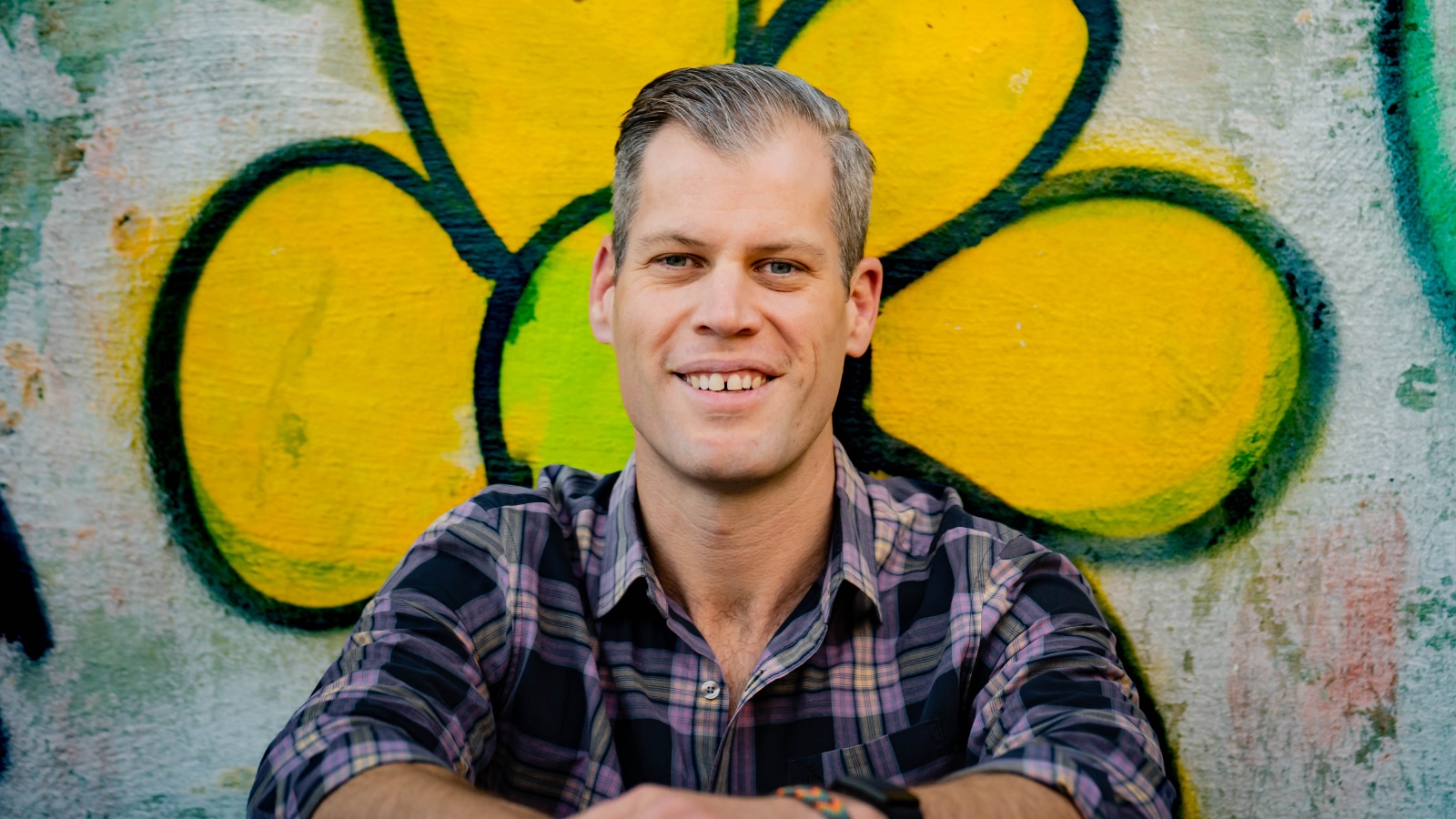 A portrait of Basil Camu, co-founder and author, smiling outdoors.